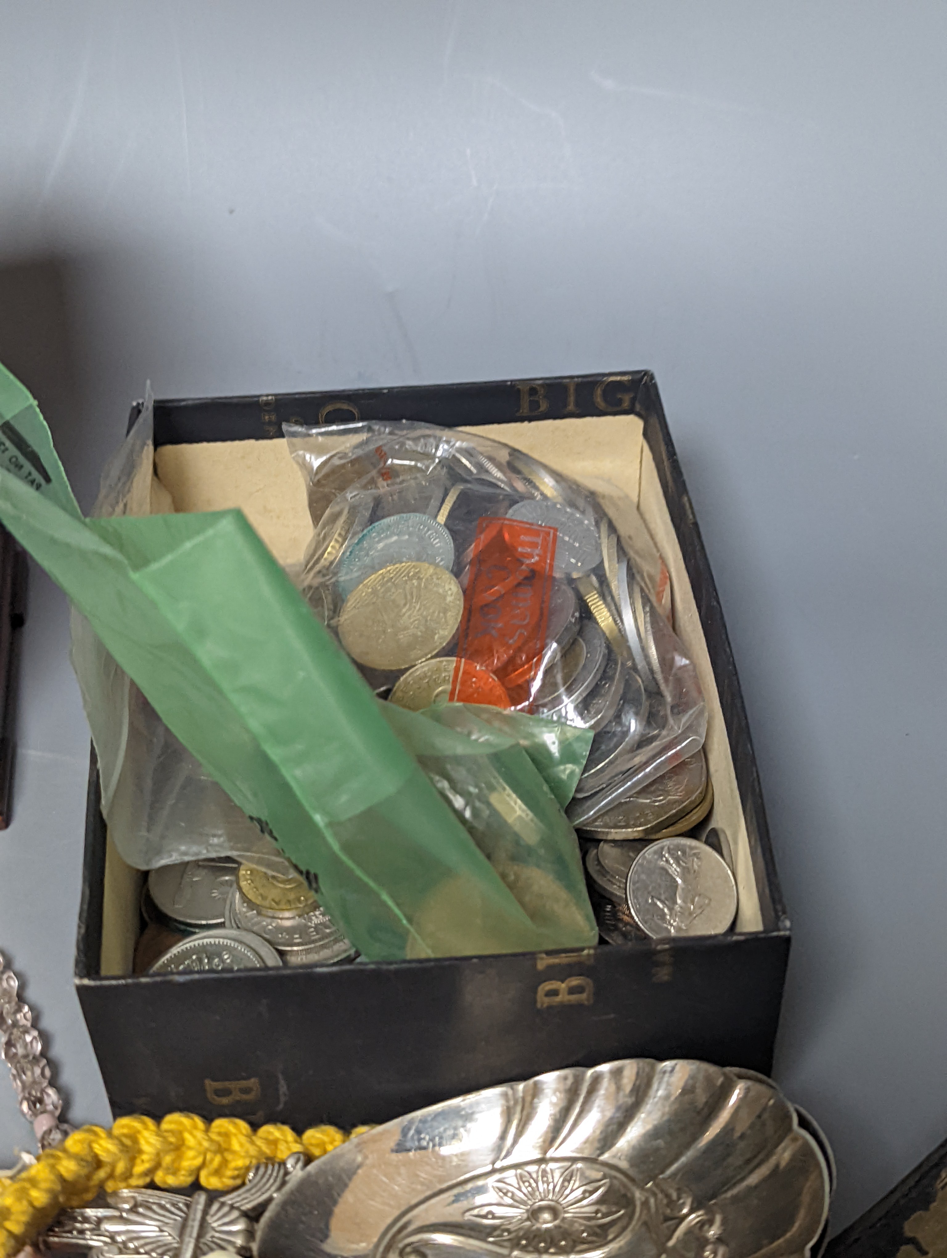 A pair of silver spoons, a small timepiece, assorted coinage and sundries